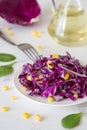 Red cabbage with corn and oil. Vegeterian salad Royalty Free Stock Photo