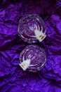 Red cabbage cut pieces close-up on a bright crumpled purple background.Fresh farm organic vegetables Royalty Free Stock Photo