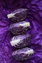 Red cabbage cut pieces close-up on a  crumpled purple background.Fresh farm organic vegetables Royalty Free Stock Photo