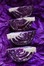 Red cabbage  pieces close-up on a  crumpled purple background.Fresh farm organic vegetables Royalty Free Stock Photo