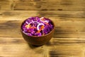 Red cabbage salad in ceramic bowl on wooden table Royalty Free Stock Photo