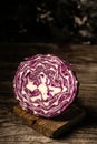 Red cabbage on vintage wooden background. The texture of the cut cabbage. vertical image, place for text Royalty Free Stock Photo