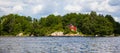 Red cabin wood house in forest on lake