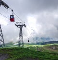 Red cable cabin down from Mannlichen with scenic view in direction to Grindelwald, Switzerland, Europe