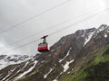 Red cable car in the background of the mountains Old red cable car at mountain Royalty Free Stock Photo