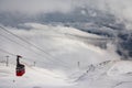 Red cable car descend from mountain peak Royalty Free Stock Photo