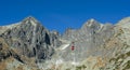 A red cable car on its way from Skalnate pleso to Lomnicky peak. Red gondola moving up to Lomnica peak in High Tatras Mountains.