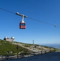 A red cable car on its way from Skalnate pleso to Lomnicky peak. Red gondola moving up to Lomnica peak in High Tatras Mountains. Royalty Free Stock Photo