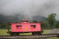 Red caboose foggy mountain Royalty Free Stock Photo