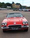 Red cabriolet on parking in cloudy day