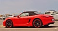 Red Cabriolet Porsche parked in front of the beach