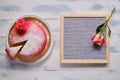 Red cake covered with marzipan with flower and sprinkled with white powdered sugar. Background for copy space