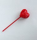 Red cakepop, heart shape, blue background