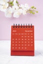 The Red calendar November 2023. Desk calendar for year 2023 and white orchid