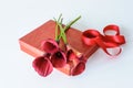 Red callas on a red gift box