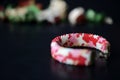 Red camouflage seed beads bracelet on a dark background Royalty Free Stock Photo