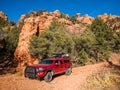 Red camper pickup truck on red gravel road in Utah canyon Royalty Free Stock Photo