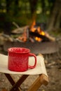 A red camping cup with a campfire Royalty Free Stock Photo