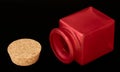 Red can of matte glass and cork on a dark background, macro shooting