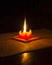 Red candle on bamboo mat with reflection 2 Royalty Free Stock Photo