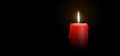 Red Candle Burning on Black Background - Isolated Realistic Candlelight