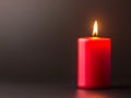 red candle burning on dark background Royalty Free Stock Photo