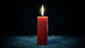 Red candle burning on dark background Royalty Free Stock Photo