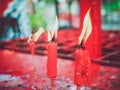 Red candle burning in old chinese church.