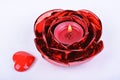 Red candle, candlestick and heart on white background