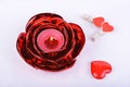 Red candle, candlestick and hearts on white background