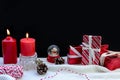 Red candle Christmas, Snow globe with a snowman and gift box on dark background. Royalty Free Stock Photo