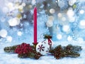 Red candle, Christmas tree toys, Christmas tree branches on a snowy background. Festive Christmas composition. Royalty Free Stock Photo