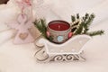 A red candle in a decorative sleigh, an angel with a carved heart. Royalty Free Stock Photo