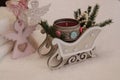 A red candle in a decorative sleigh, an angel with a carved heart. Royalty Free Stock Photo