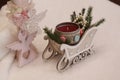 A red candle in a decorative sleigh, an angel with a carved heart. Royalty Free Stock Photo