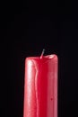 Red candle extinguished on black background Royalty Free Stock Photo