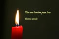 Red Candle with flame and dark background, french text Royalty Free Stock Photo