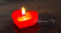 Red candle in the form of a heart on a dark background with the inscription of valentines day. Congratulations on Valentine`s Day Royalty Free Stock Photo