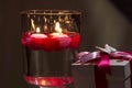 Red candle lights in a brown glassess and gift for Valentine day Royalty Free Stock Photo