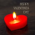 Red candle shaped heart on a dark background with the words happy Valentines day. Congratulations on Valentine`s Day_ Royalty Free Stock Photo