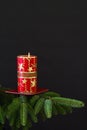 Red candle on spruce branch Royalty Free Stock Photo