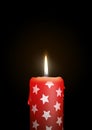 Red Candle with Starlet Texture on Black Background - Isolated C