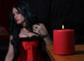 Red Candle With Woman wearing Red Corset Royalty Free Stock Photo