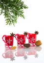 Red candles, candle holders with crystal snowflakes, sugar canes and anise stars, isolated on reflective white perspex background