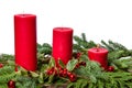 Red candles with cedar boughs and holly Royalty Free Stock Photo