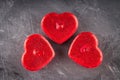 Red candles in the form of hearts on a gray background. The symbol of the day of lovers. Valentine's Day. Concept February 14. Royalty Free Stock Photo