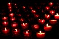Red candles with glowing lights in darkness in church. Peace and hope background. Religion concept. Royalty Free Stock Photo