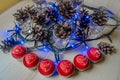 Red candles Heart-shaped among, cones and blue garlands. Christmas candles Royalty Free Stock Photo