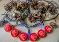 Red candles Heart-shaped among, cones and blue garlands. Valentine& x27;s candles Royalty Free Stock Photo