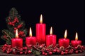 Red candles and red plant fruits for festive holiday celebration